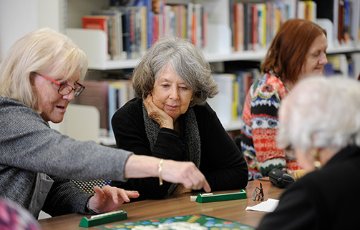 Group of senior women playing a board game